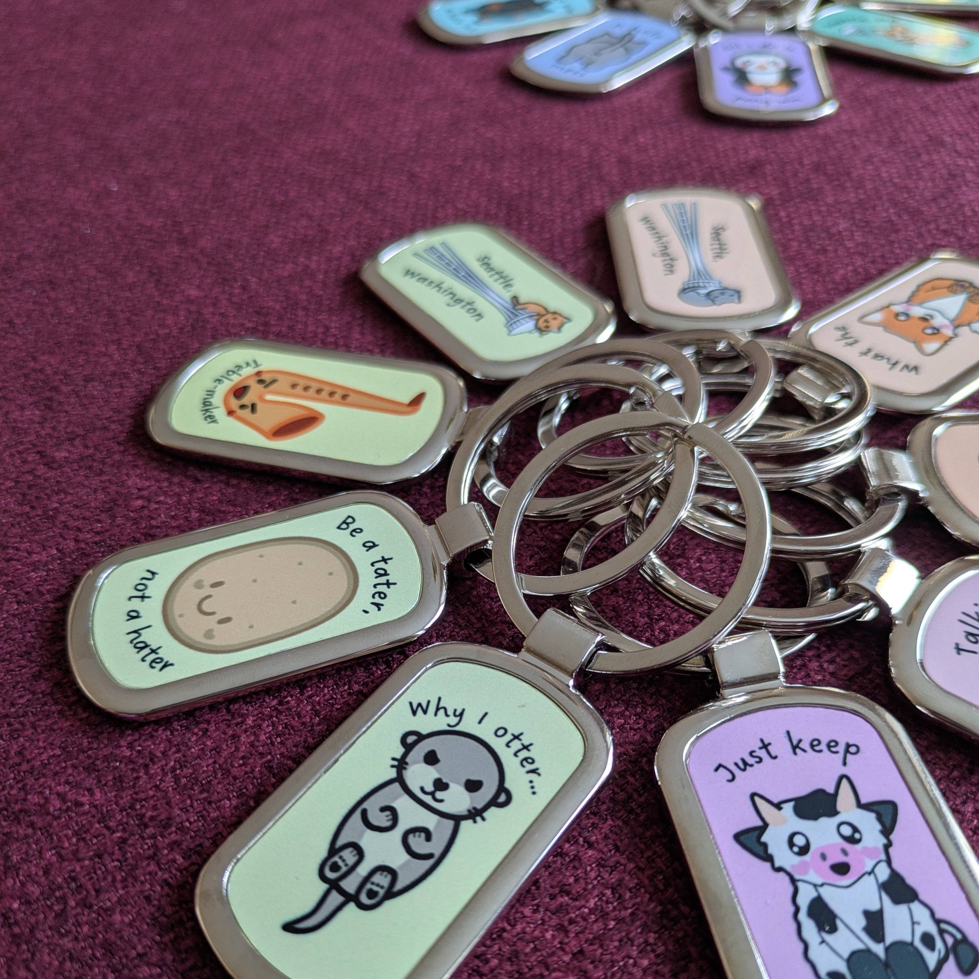 Keychains with various designs posed in a circle, photographed from the side