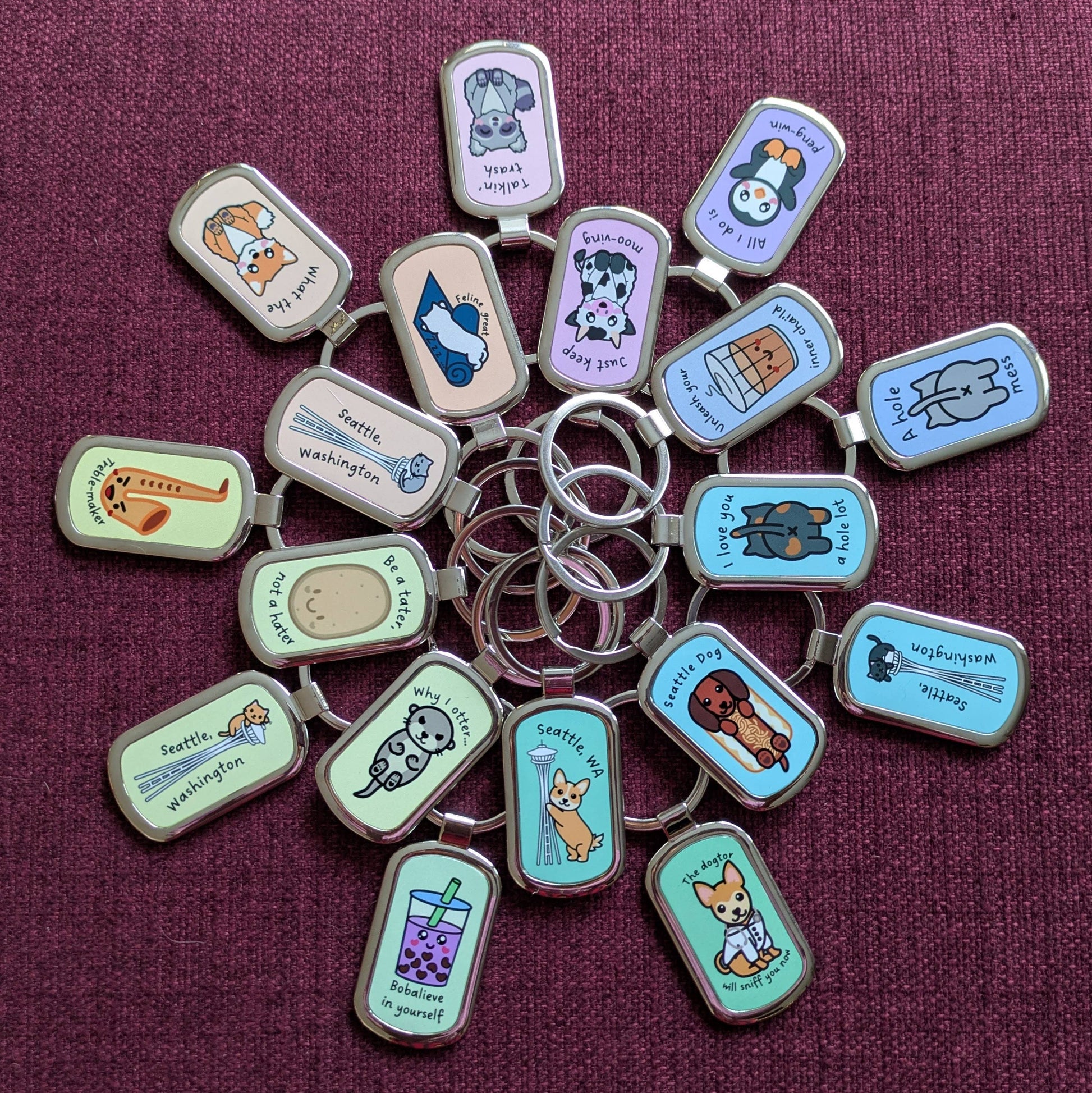 Keychains of various designs displayed in two concentric circles in a rainbow gradient