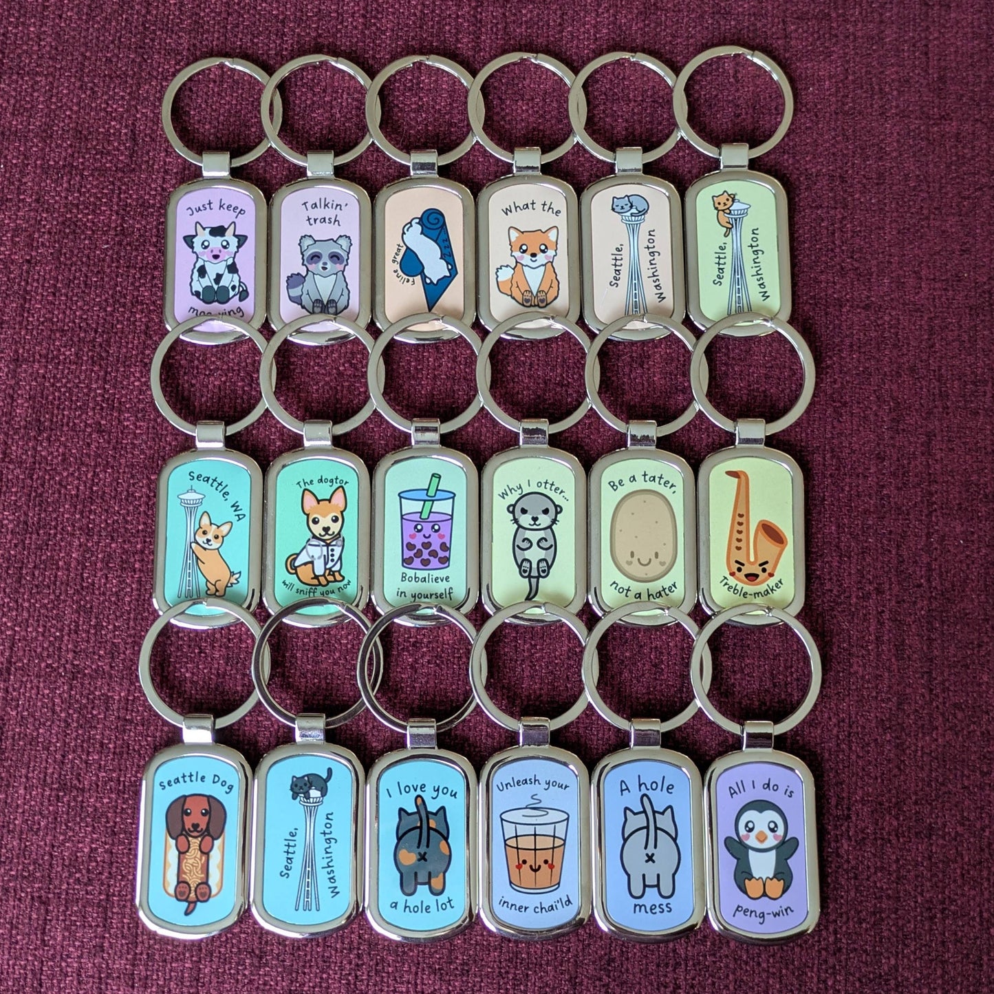 Eighteen keychains displayed in 3 rows of 6 in rainbow gradient