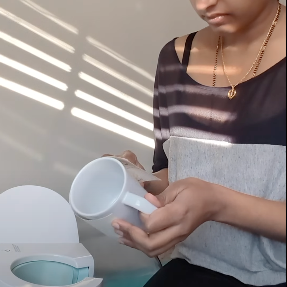 A photo of Sneha preparing a mug for the heat press